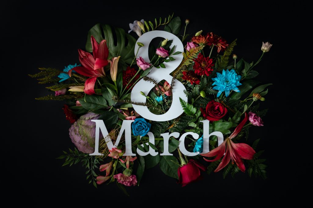 Colorful 8 March. Floral Greeting card. Happy Women's Day. Flower and leaves flat lay spring holiday background, space for text. Nature Trendy Design. Happy Mother's Day.