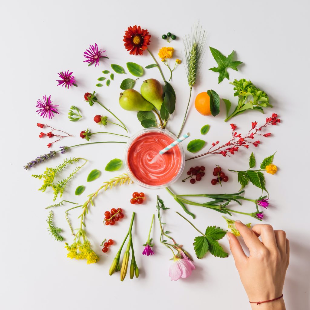 Various natural things neatly arranged in circle with homemade strawberry smoothie. Flat lay. Nature concept.